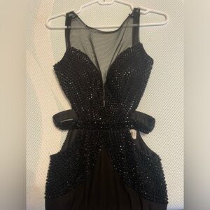 Backless and low cut jeweled dress with cut outs and adjustable corse back.